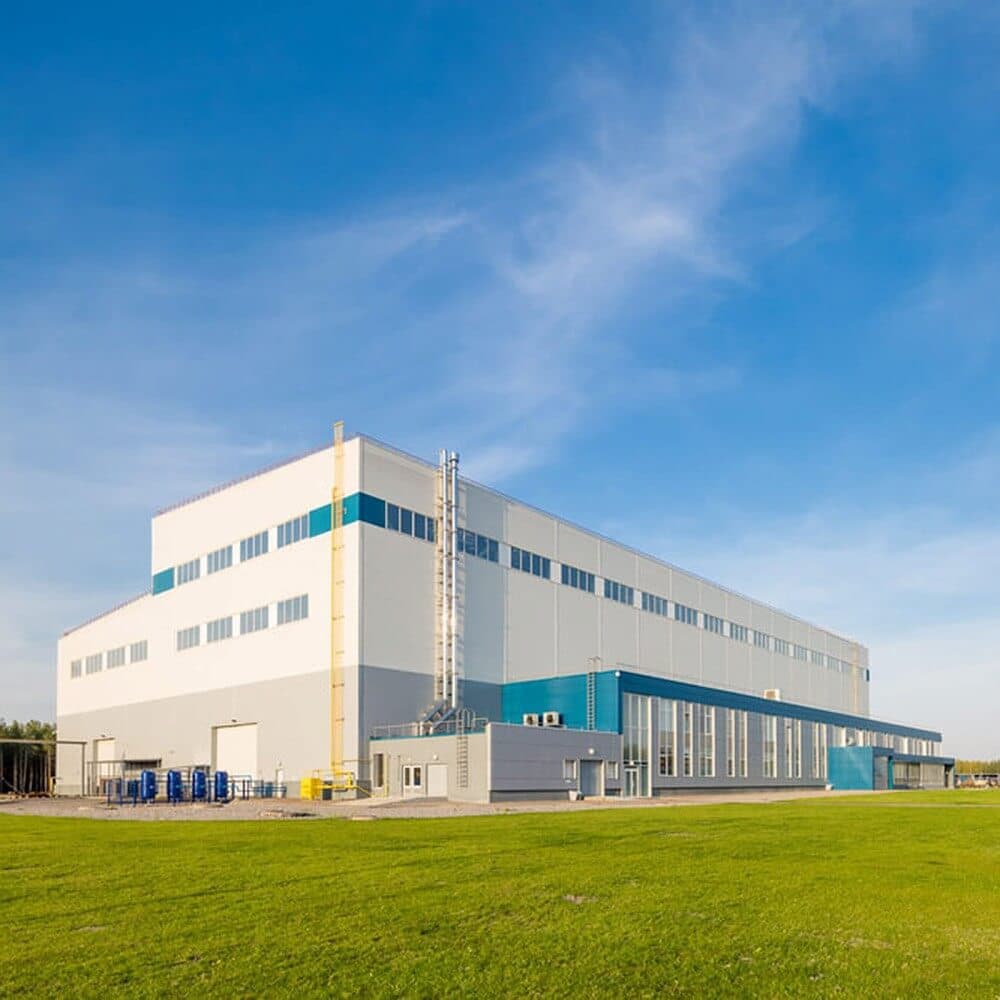 Industrial warehouse building under a blue sky